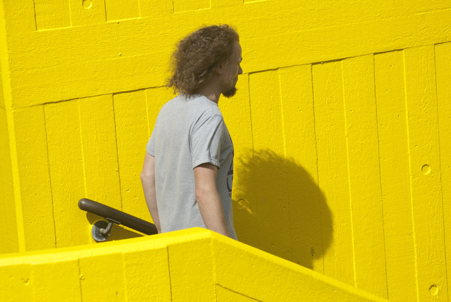 Man and shadow, yellow background
